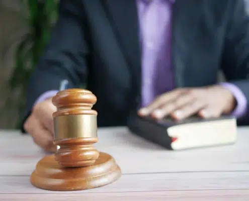An attorney holding a wooden gavel.