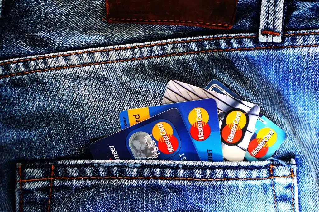 Different credit cards on denim jacket.