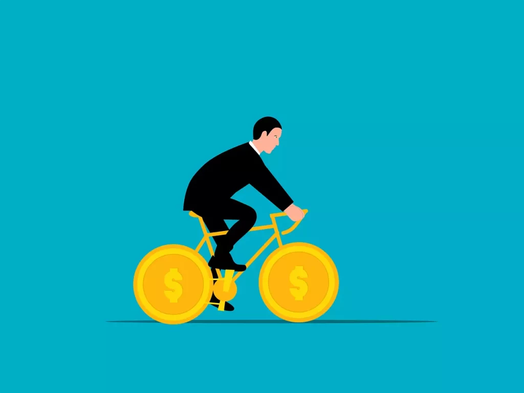 Businessman riding on a bike which wheels are coins.