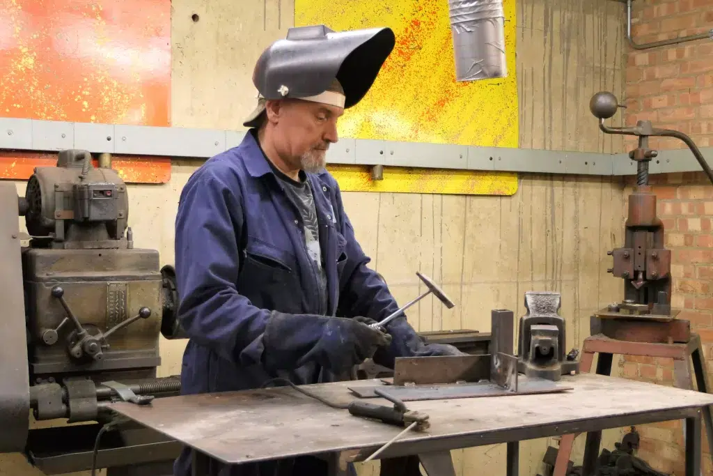 An old engineer doing welding.
