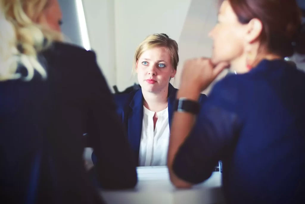 A female investor listening to the other two investors.