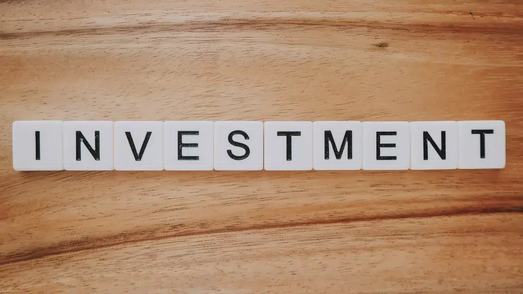 White cubes forming the word investment.