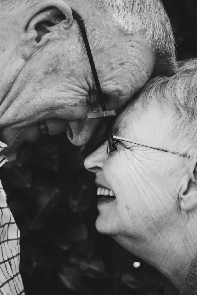 Elderly couple having sweet moments by facing each other.