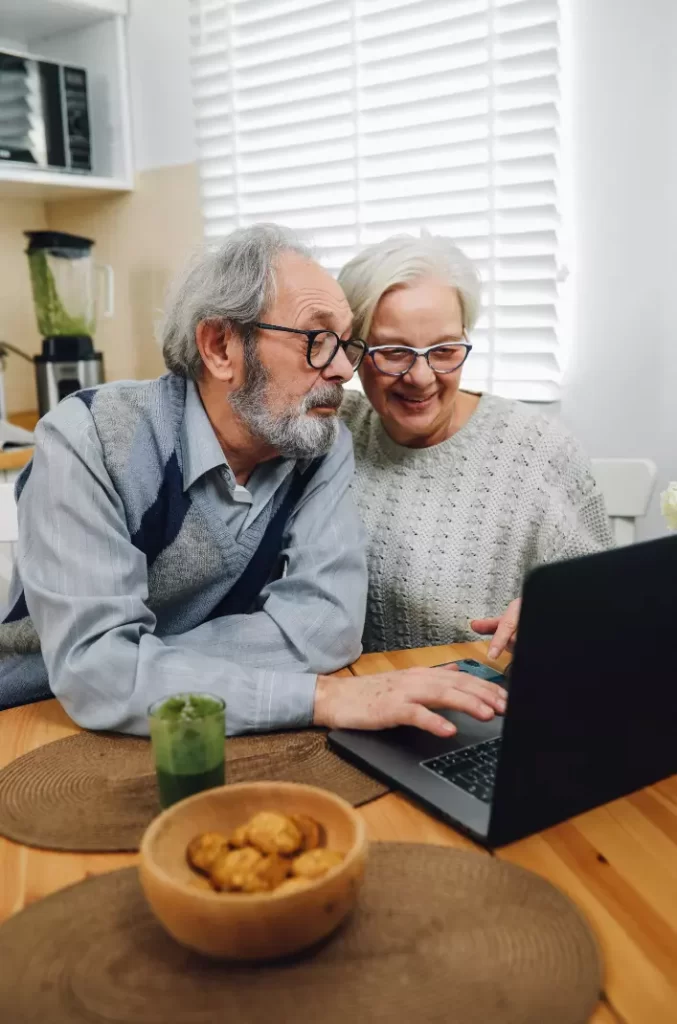 Elderly couple taking aged care financial advice online.