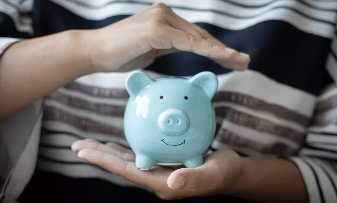 Protecting savings in piggy bank for income protection insurance.