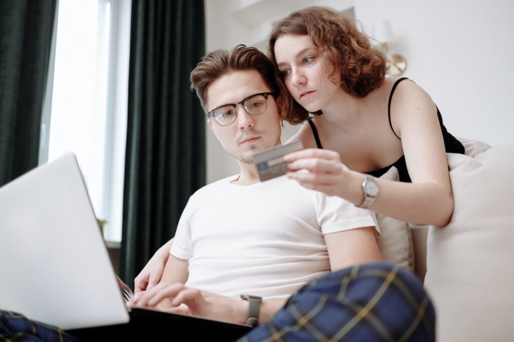 Couple thinking about using a credit card.
