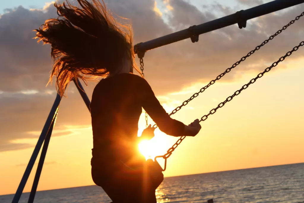 Girl on swing during golden hour.