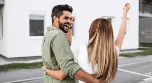 Happy couple buying a house.