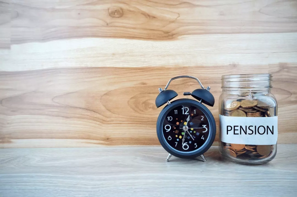 Pension savings jar and alarm clock.