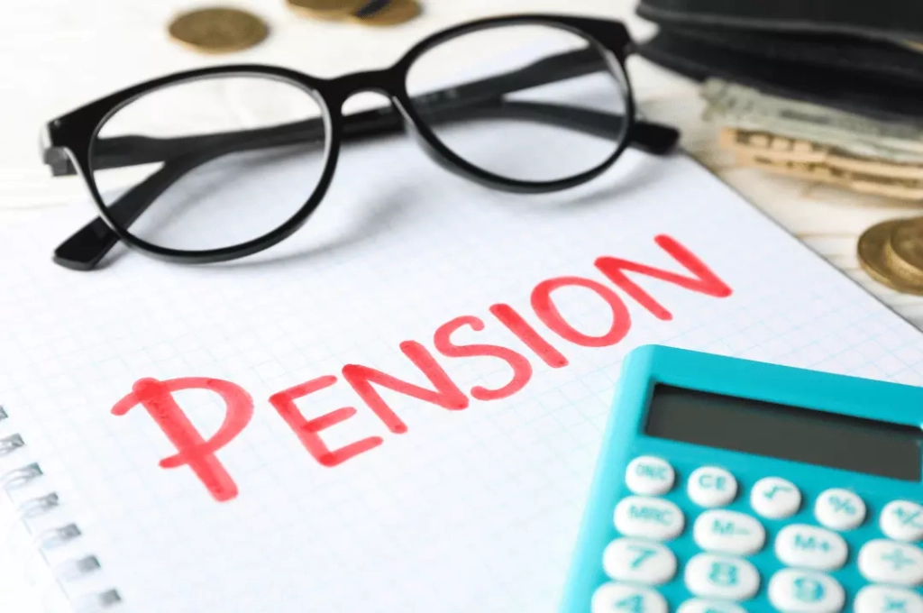Pension word with calculator and eye glass.