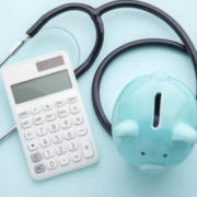 Stethoscope with calculator and piggy bank.