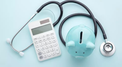 Stethoscope with calculator and piggy bank.
