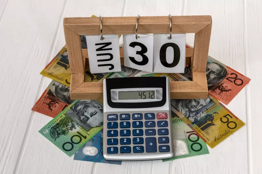 Wooden calendar with calculator and Australian money.