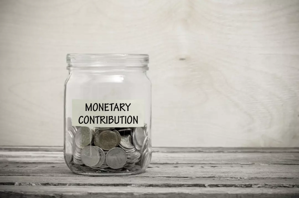 Monetary contribution jar filled with coins.