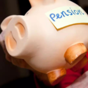 Pensioner withdrawing money from piggy bank.