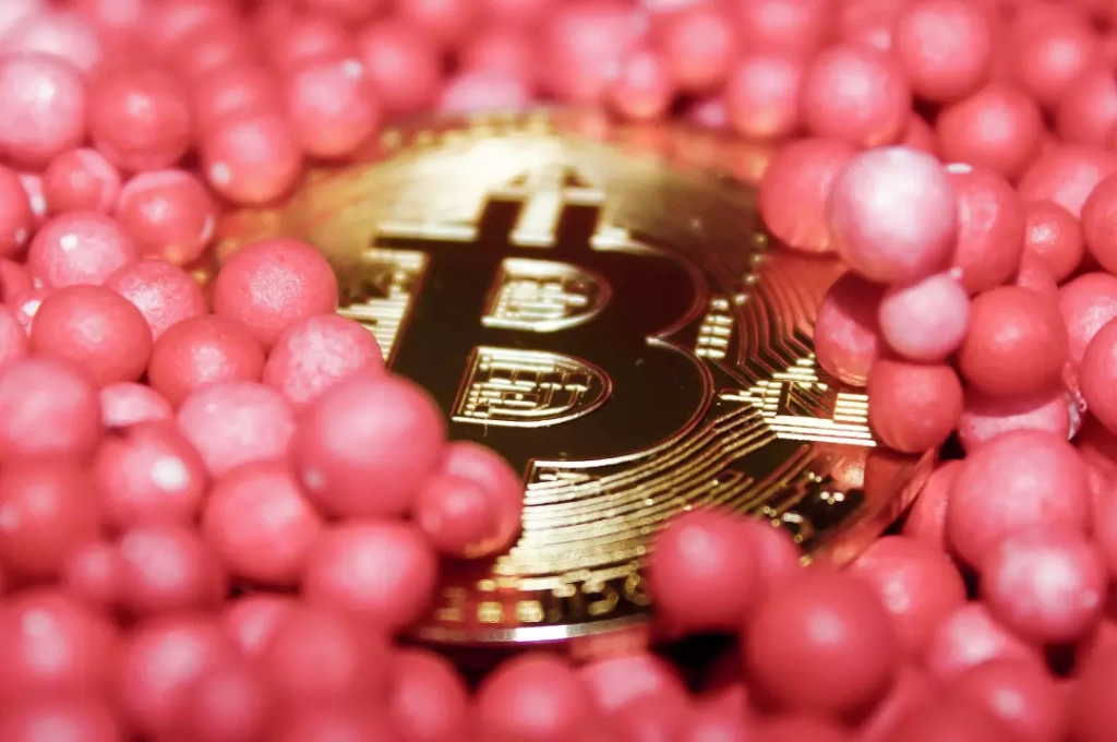 Bitcoin surrounded by pink balls.
