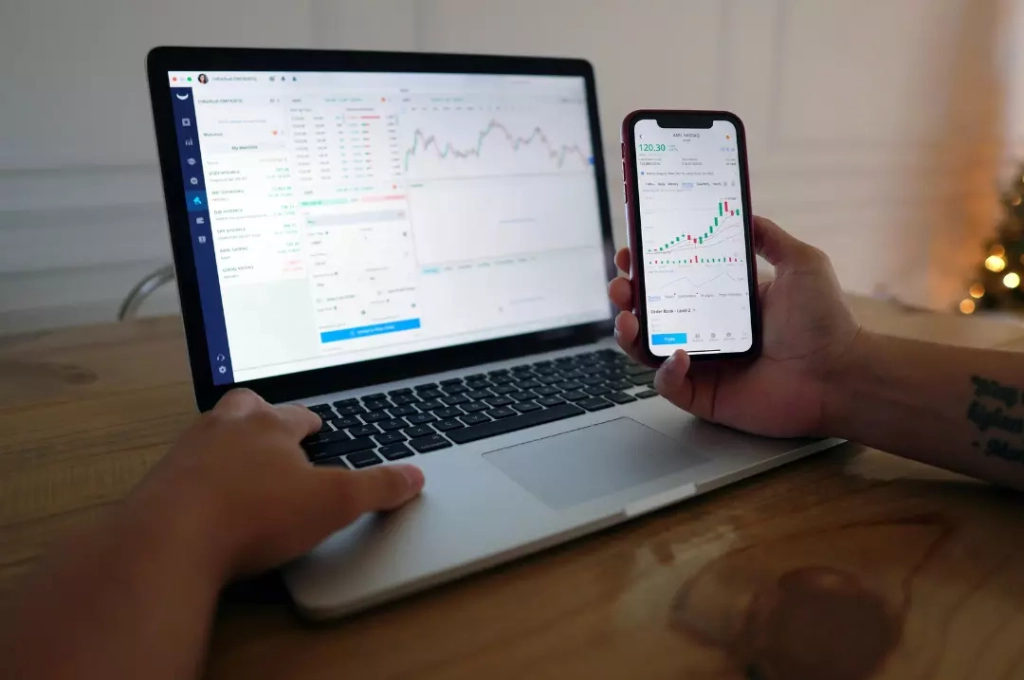 Monitor the market through laptop and phone.