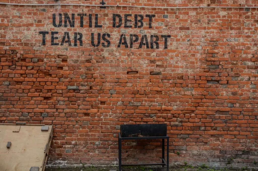 Until debt tear us apart written in the wall.