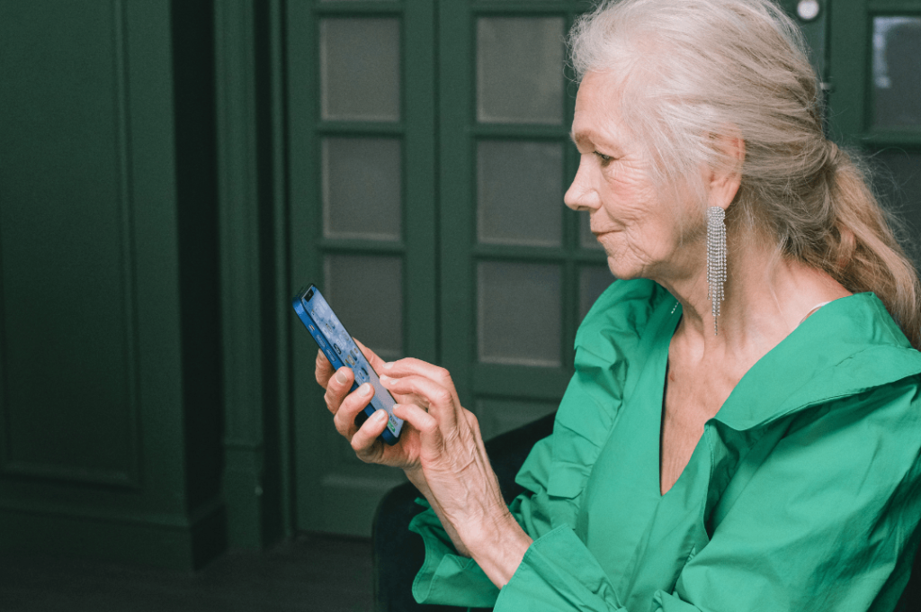 A self-funded retiree using her smartphone.