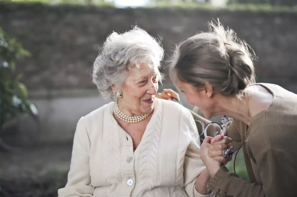 An elderly parent talking with her daughter about inheritance.