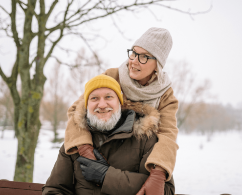Elderly couple in winter clothing.