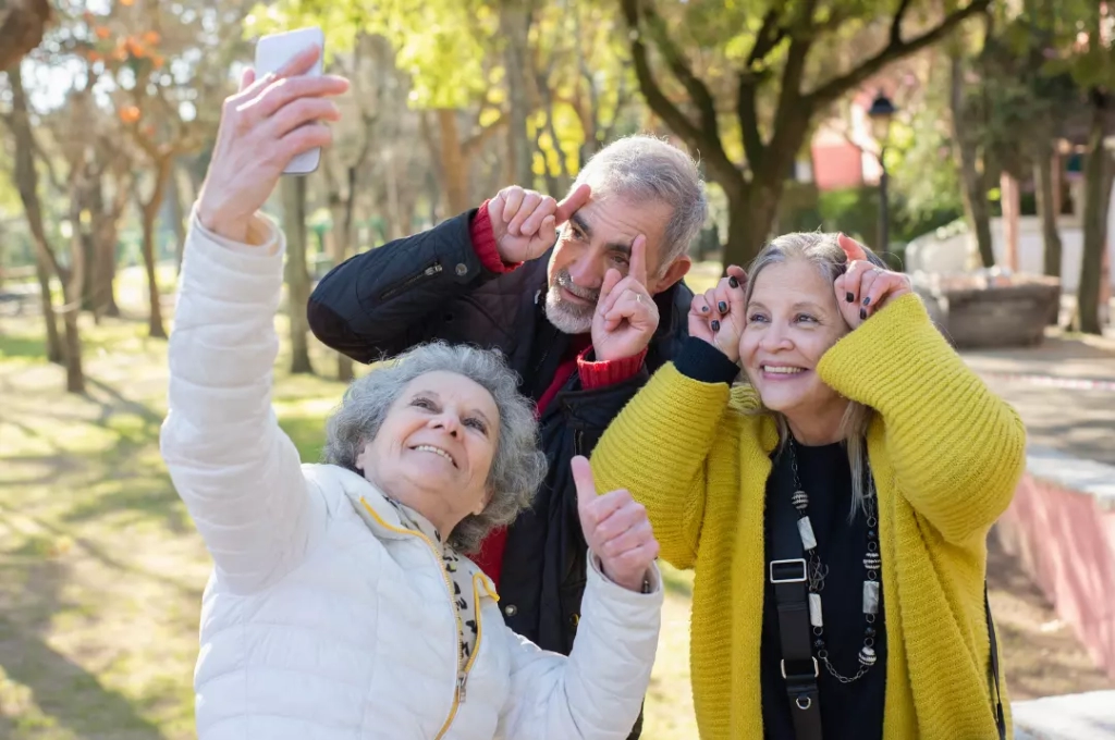 Three old happy people having a selfie together.