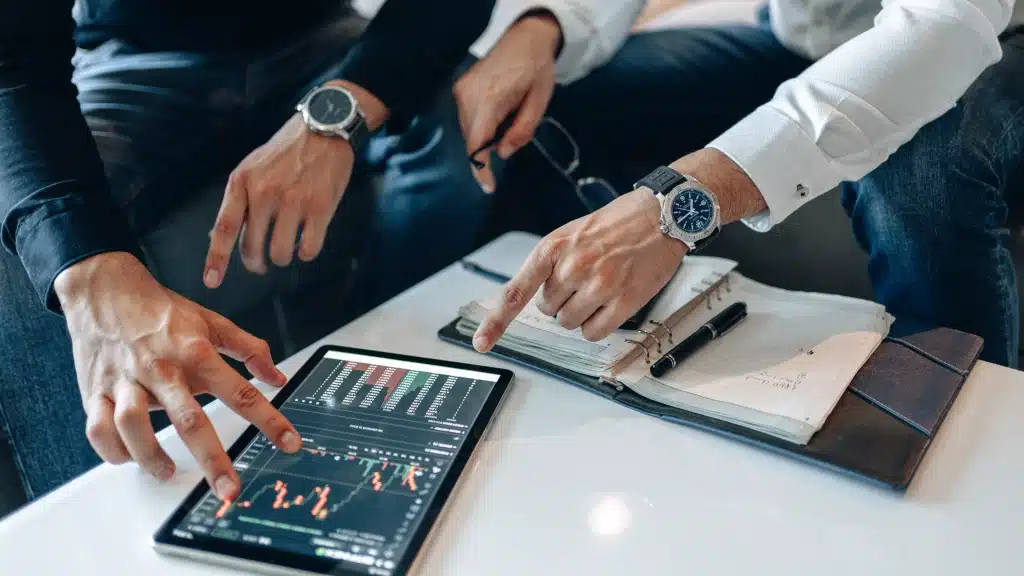 Two people assessing the graph on the tablet screen.