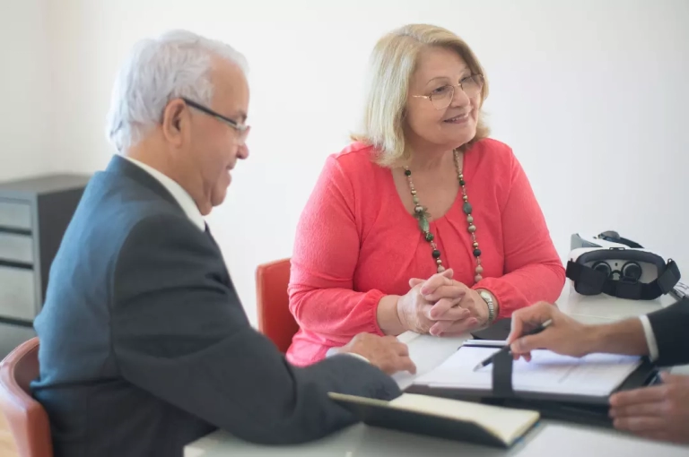 Old couple choosing investment options for their pension.
