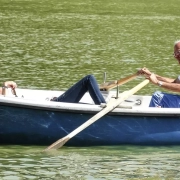 Old couple riding on a boat.