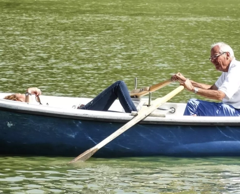 Old couple riding on a boat.